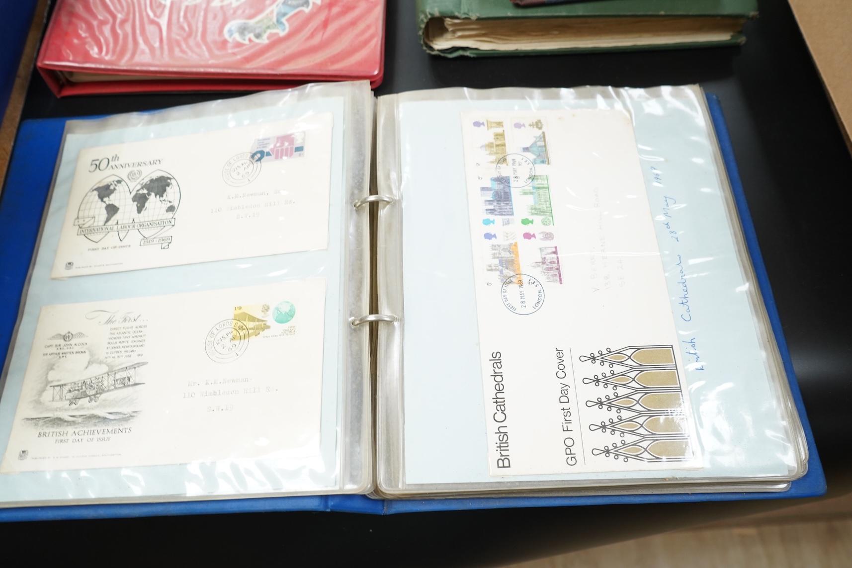 Four stamp albums including a first day cover album